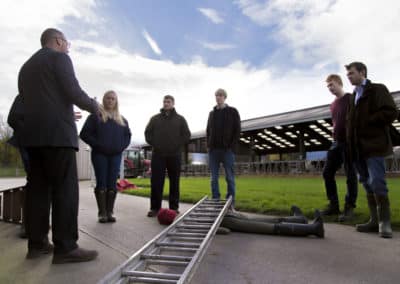 Training session on farm safety procedures outdoors.