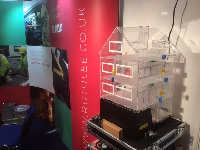 Exhibition stand with construction model and colourful signage.