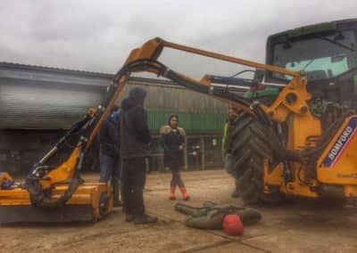 Farm safety training with machinery and dummy.