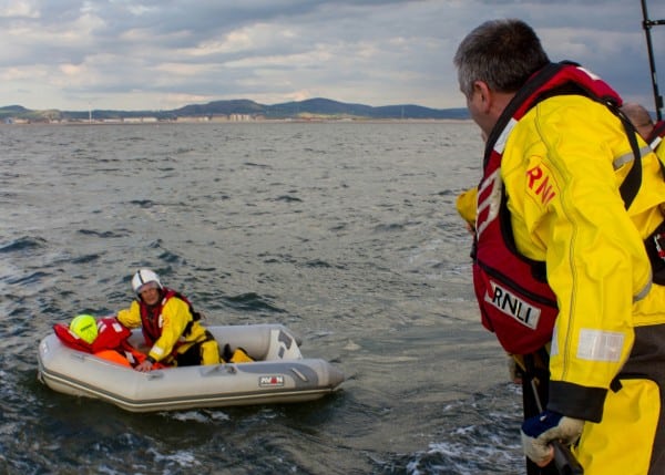 Lifeboat rescue at sea by RNLI crew.
