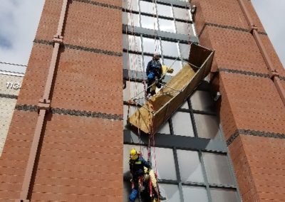 Firefighters performing a high-rise rescue drill.
