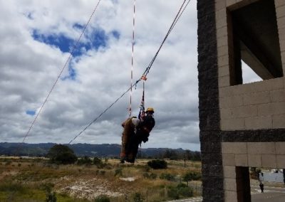 Firefighter performing a high-rise rescue training.