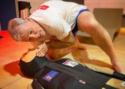 Man practising first aid on a training dummy.