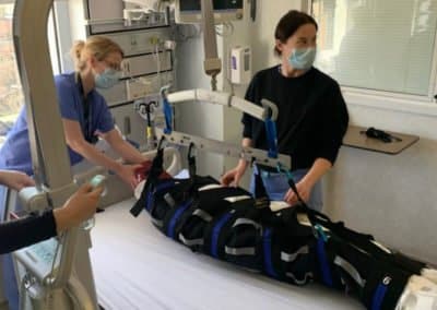 Healthcare professionals using a patient lift in hospital.