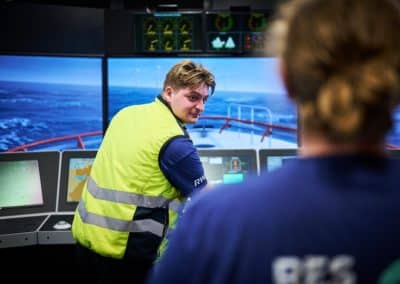 CTV Two workers in a ship simulation control room.